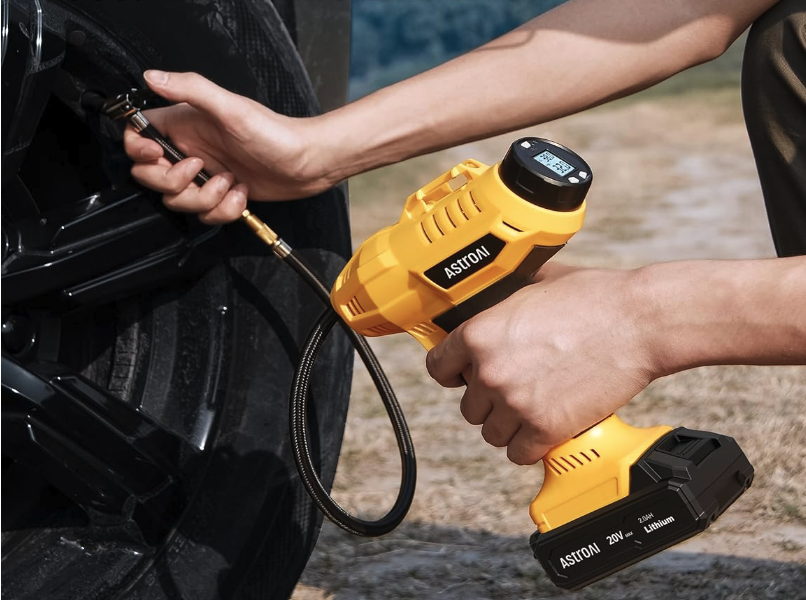 Portable tire inflator adding air to flat tire